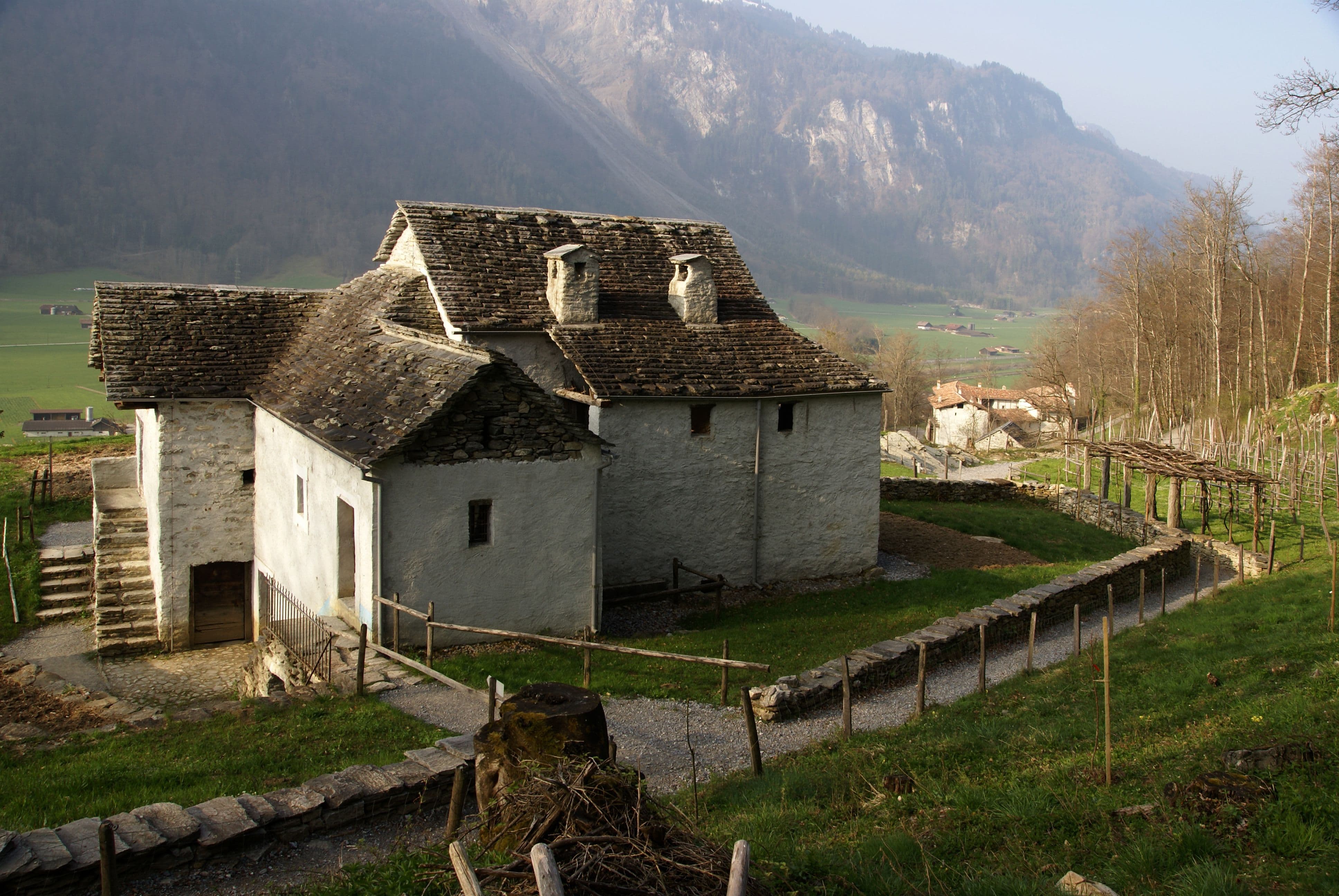 Freilichtmuseum Ballenberg, Wohnhäuser aus Cugnasco, Nordansicht. Die drei Gebäude erzählen vom Alltag Tessiner Bauernfamilien, der sich nicht nur in einem Wohnhaus, sondern einem Dutzend Bauten abspielte. Foto: Ballenberg, Freilichtmuseum der Schweiz 2011.